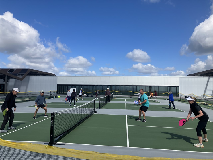 members playing a pickleball game on the roof